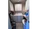 Functional laundry area with washer, dryer, overhead cabinets, and utility sink space at 710 E Arizona Ave # A, Deland, FL 32724