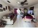 Spacious living room with tile floors, ceiling fan and sliding glass doors leading to outdoor patio at 710 E Arizona Ave # A, Deland, FL 32724