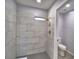 New bathroom with gray tiled shower and modern fixtures at 713 Greenleaf Ln, Lake Wales, FL 33853