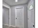 Bright entryway featuring modern flooring, neutral walls, and classic white doors at 713 Greenleaf Ln, Lake Wales, FL 33853