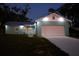 This home offers a metal roof, light blue exterior, a one car garage, and exterior lighting at 713 Greenleaf Ln, Lake Wales, FL 33853