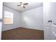 Neutral bedroom with carpet, ceiling fan, closet, and a sunlit window at 714 Franklin Ct, Haines City, FL 33844