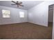 Bright bedroom with plush carpeting, two windows and neutral wall color at 714 Franklin Ct, Haines City, FL 33844