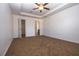 Spacious carpeted main bedroom with a ceiling fan and an ensuite bathroom at 714 Franklin Ct, Haines City, FL 33844