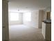 A spacious living room area offering natural light with a kitchen bar in the corner at 720 Siena Palm Dr # 101, Celebration, FL 34747