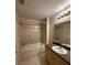 Bathroom featuring a shower-tub combo and neutral-toned tiles at 727 Siena Palm Dr, Celebration, FL 34747