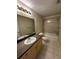 Bathroom featuring shower-tub combo, toilet, vanity with sink and countertop, a large mirror, and tiled floors at 727 Siena Palm Dr, Celebration, FL 34747