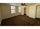 Spacious carpeted bedroom features a ceiling fan, closet, and two large windows for lots of natural light at 727 Siena Palm Dr, Celebration, FL 34747