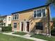 Two-story townhome featuring a stucco facade, and well-maintained landscaping at 727 Siena Palm Dr, Celebration, FL 34747