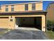 Exterior image showing townhome, large garage, driveway, and front walkway, with some landscaping at 727 Siena Palm Dr, Celebration, FL 34747