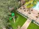 Overhead shot of playground with slide surrounded by artificial turf, next to the community pool area at 727 Siena Palm Dr, Celebration, FL 34747