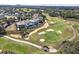 Expansive aerial view of luxury homes bordering a pristine golf course, set against a backdrop of clear skies at 7471 Gathering Loop, Reunion, FL 34747