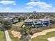 Scenic aerial view of luxurious homes alongside a golf course, set against a clear blue sky at 7471 Gathering Loop, Reunion, FL 34747