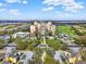 Elevated view of a resort featuring luxurious condos, golf courses, manicured landscape, and lush greenery at 7471 Gathering Loop, Reunion, FL 34747