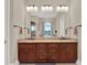 Bright bathroom featuring dual sinks, granite countertops, and modern fixtures for a luxurious experience at 7471 Gathering Loop, Reunion, FL 34747