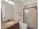 Cozy bathroom with granite countertop, tile shower and neutral color palette at 7471 Gathering Loop, Reunion, FL 34747