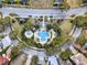 Aerial view of a community pool surrounded by trees and landscaping at 7471 Gathering Loop, Reunion, FL 34747