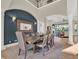 Elegant dining room with a large wooden table, statement mirror, and dark blue accent wall at 7471 Gathering Loop, Reunion, FL 34747