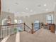 Well-lit hallway with decorative chandelier and a comfortable seating area at 7471 Gathering Loop, Reunion, FL 34747