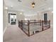 Spacious hallway featuring decorative wrought iron railing and elegant lighting at 7471 Gathering Loop, Reunion, FL 34747