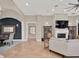 Spacious living room featuring tile flooring, a fireplace, and modern decor, with a dining area to the left at 7471 Gathering Loop, Reunion, FL 34747