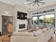 Well lit living area featuring a large fireplace, decorative cabinets and expansive sliding glass doors to the backyard at 7471 Gathering Loop, Reunion, FL 34747