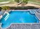 Aerial view of a private pool and spa with brick patio and golf course views, perfect for relaxation at 7471 Gathering Loop, Reunion, FL 34747