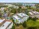 Aerial view of condo complex showcasing lush landscaping, beautiful architecture, and parking areas at 7652 Whisper Way # 401, Reunion, FL 34747