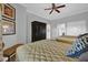 Bedroom showcasing two beds, neutral walls, ceiling fan, and natural lighting at 7652 Whisper Way # 401, Reunion, FL 34747