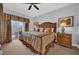 Inviting bedroom featuring plush bedding, balcony access, and bedside tables at 7652 Whisper Way # 401, Reunion, FL 34747