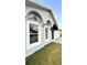 The front exterior of the house is a light grey color with decorative accents and a dark awning above the front door at 856 Jarnac Dr, Kissimmee, FL 34759