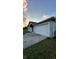 Shows a home's two car garage, light-colored siding and patterned brick driveway at 856 Jarnac Dr, Kissimmee, FL 34759