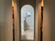 Arched hallway leading to a tiled bathroom with natural light and closet space at 856 Jarnac Dr, Kissimmee, FL 34759