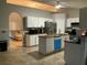 Open concept kitchen with an island and stainless steel appliances, adjacent to living room at 856 Jarnac Dr, Kissimmee, FL 34759