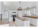 Bright kitchen featuring an island, granite countertops, white cabinets and black appliances at 856 Jarnac Dr, Kissimmee, FL 34759