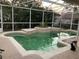 Enclosed pool area with green water, clear skies, and plants surrounding the water at 856 Jarnac Dr, Kissimmee, FL 34759