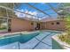 Private screened-in swimming pool with a patio area, perfect for outdoor entertaining at 856 Jarnac Dr, Kissimmee, FL 34759