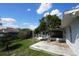 View of backyard from wood deck, showcasing a fenced-in pool area and lawn at 105 Shaddock Dr, Auburndale, FL 33823