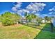 Well-maintained backyard featuring a black iron fence that enhances the landscaping and provides a secure perimeter at 105 Shaddock Dr, Auburndale, FL 33823