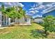 This backyard features a wooden deck, white siding and a black fence, perfect for a serene outdoor setting at 105 Shaddock Dr, Auburndale, FL 33823