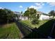 Wide fenced backyard featuring a well-maintained lawn and screened-in pool area at 105 Shaddock Dr, Auburndale, FL 33823