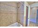 Bathroom features a shower and tub combination with decorative tile and gold fixtures at 105 Shaddock Dr, Auburndale, FL 33823