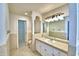 Bathroom with tile surround, large mirror and bright lighting at 105 Shaddock Dr, Auburndale, FL 33823