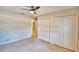 Carpeted bedroom features double closets and a ceiling fan at 105 Shaddock Dr, Auburndale, FL 33823