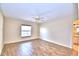 Spacious bedroom with hardwood floors, natural light from the window, and an ensuite bathroom at 105 Shaddock Dr, Auburndale, FL 33823