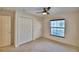 The bedroom has carpet, a ceiling fan, and double closets for storage at 105 Shaddock Dr, Auburndale, FL 33823