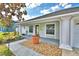 Inviting front porch with beautiful landscaping and covered entry at 105 Shaddock Dr, Auburndale, FL 33823