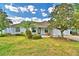 Charming single story home with well-manicured lawn and beautiful palm tree at 105 Shaddock Dr, Auburndale, FL 33823