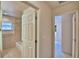 Hallway view to bathroom and bedroom, with tile floors at 105 Shaddock Dr, Auburndale, FL 33823