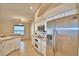 Bright kitchen featuring stainless appliances, tiled floors and countertops, and views of the breakfast nook at 105 Shaddock Dr, Auburndale, FL 33823